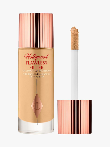 Charlotte Tilbury Hollywood Flawless Filter bottle of foundation with rose gold cap and wand to the side on light gray background